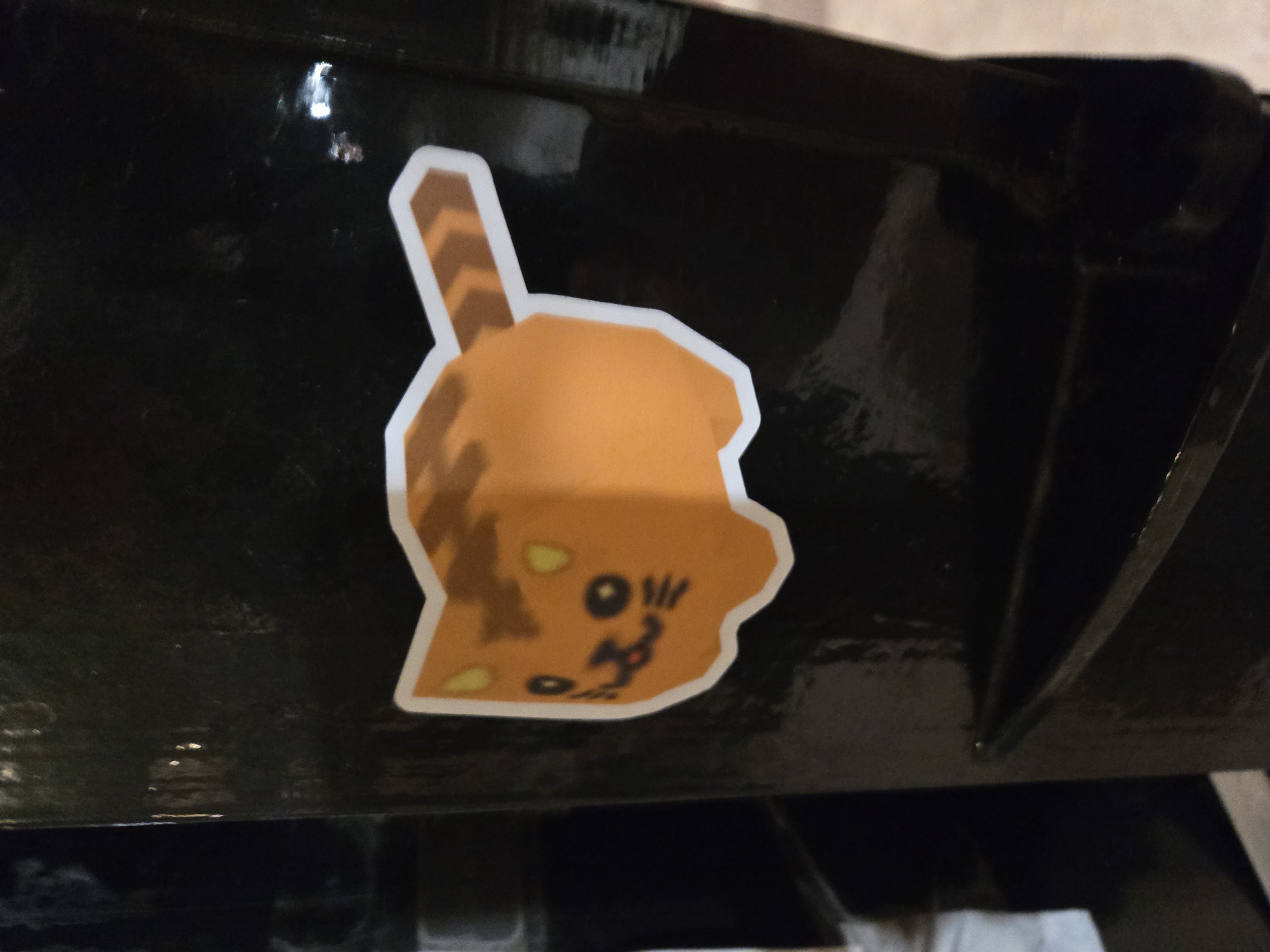 Sticker of a low poly geometric shaped cat on a lamppost
