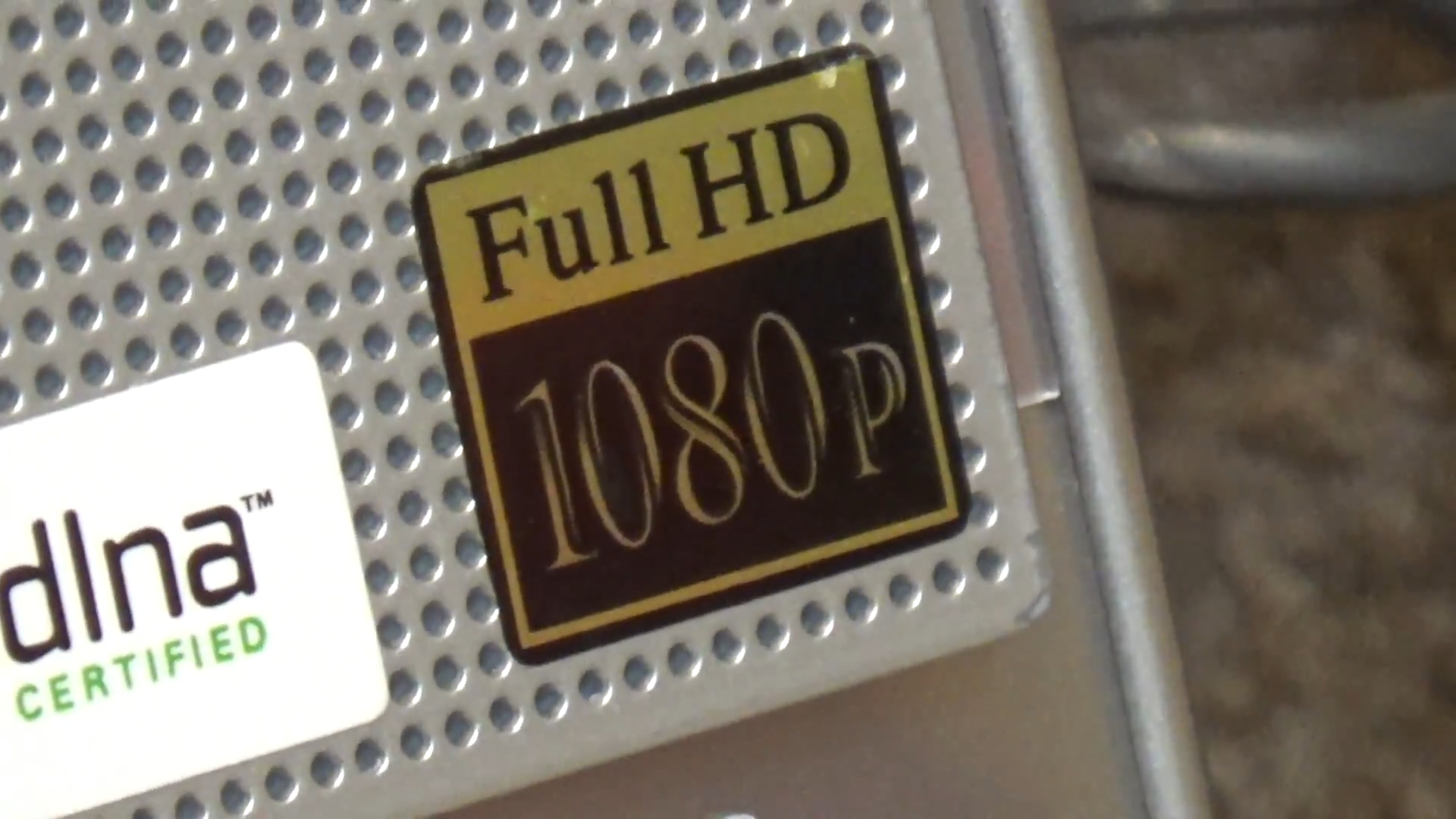 a silver sony computer with the sticker "Full HD 1080p" in fold in the corner, like the meme