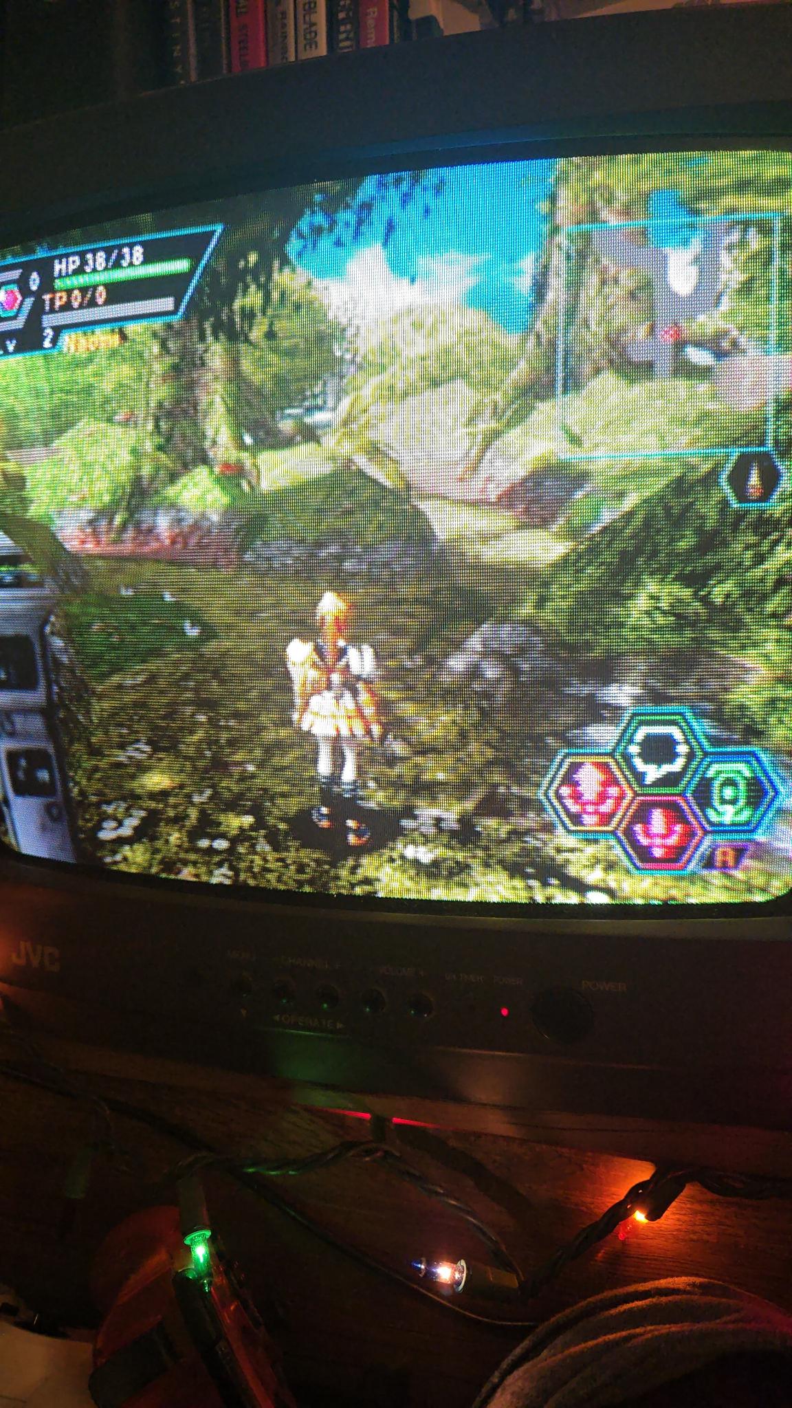 Close up of the tv showing a robot girl in the forest stage of the game. Everything is lush and colourful