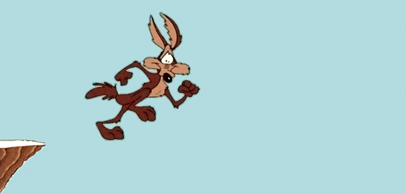 Wile E. Coyote in mid-air running pose, look of horrid realization on his face, with the edge of a cliff just visible on the left.
