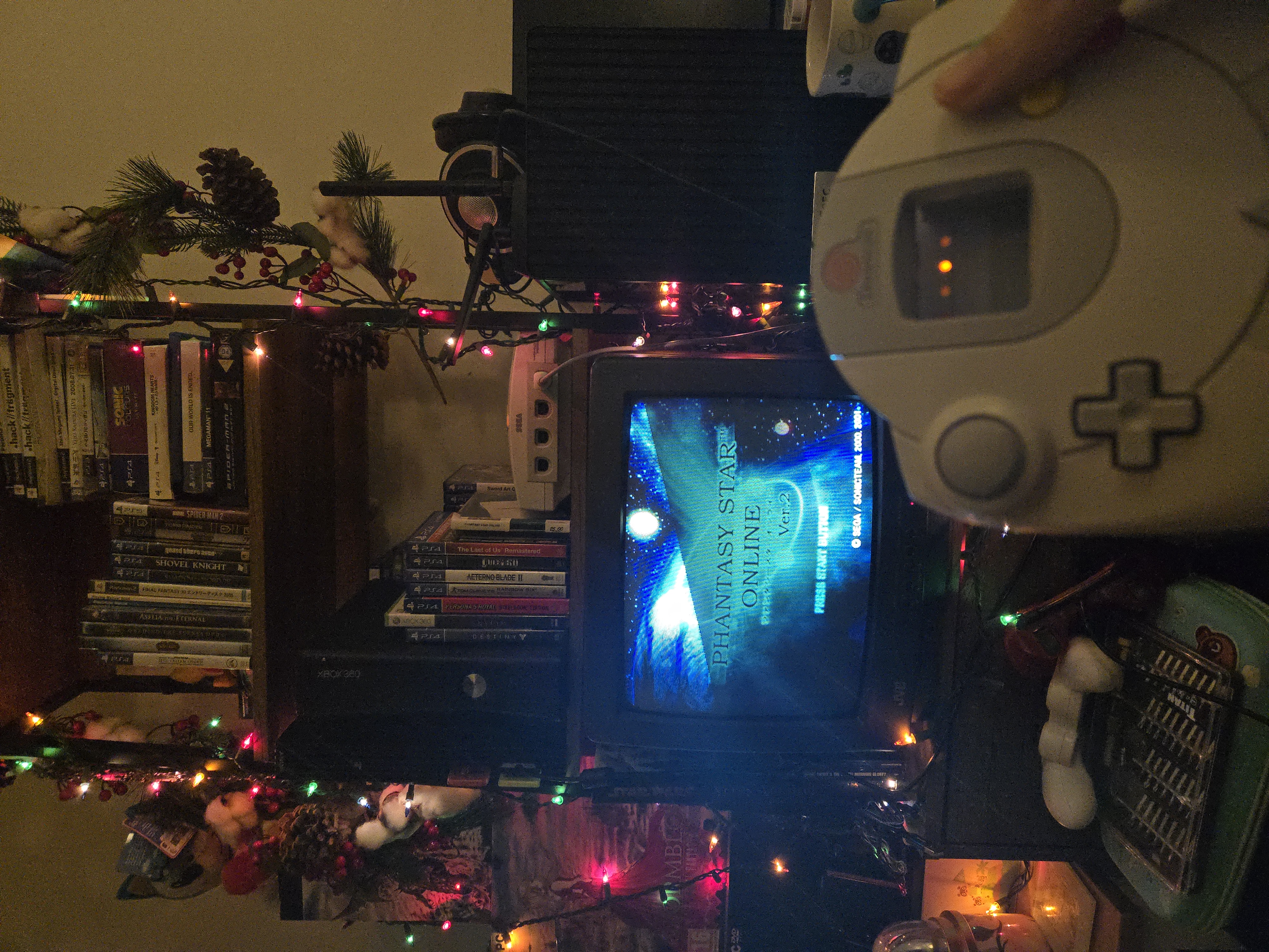 Holding up a dreamcast controller in front of a crt showing the phantasy star online version 2 title screen
