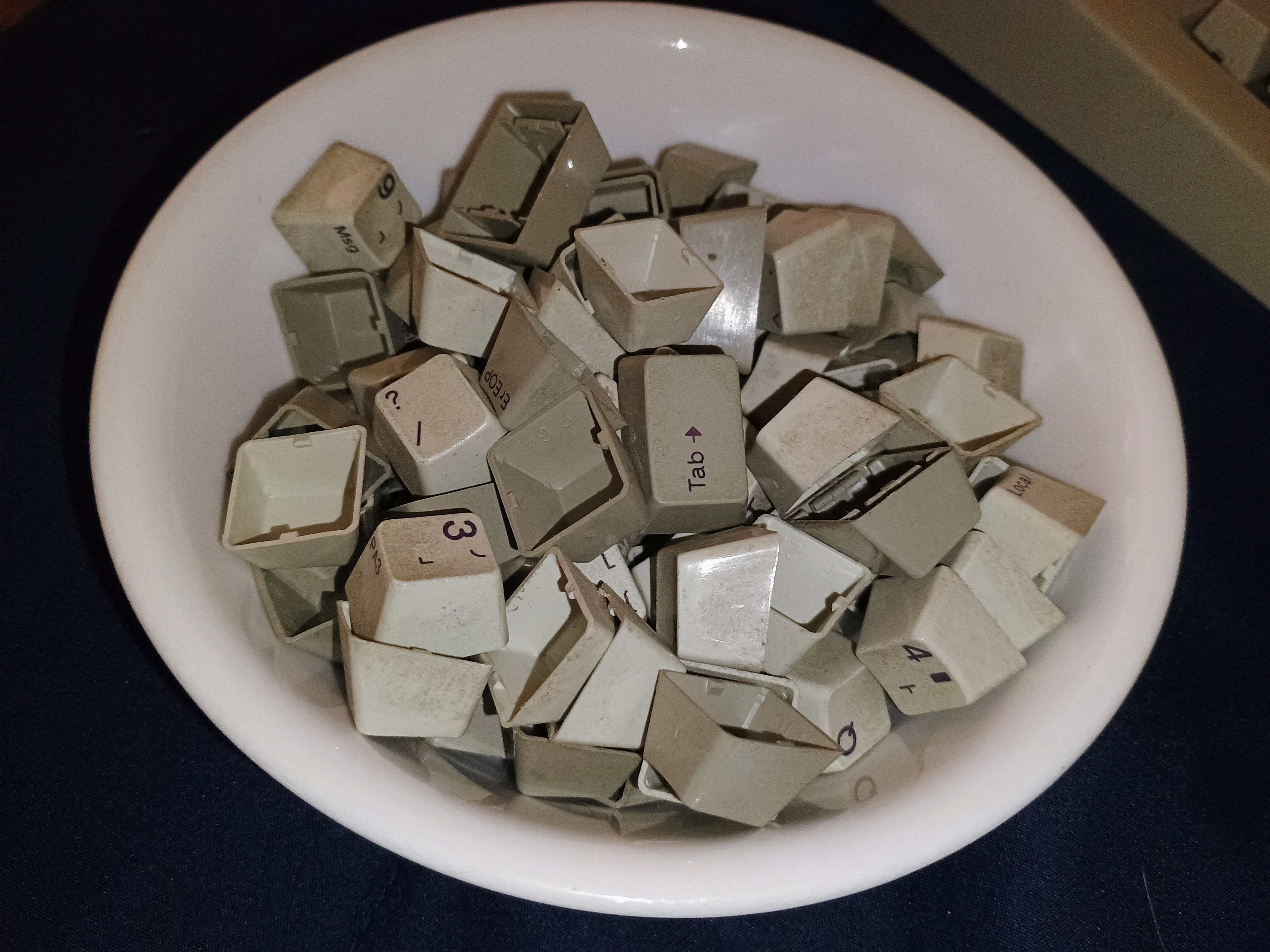 A bunch of keycaps in a bowl